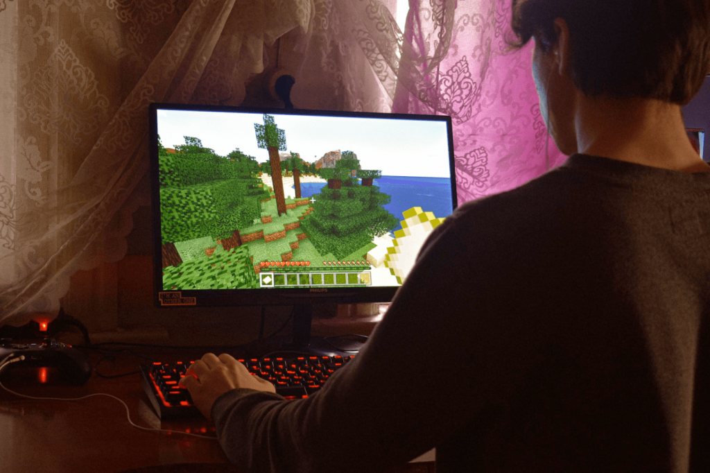 An image of a man playing an online game on a computer.