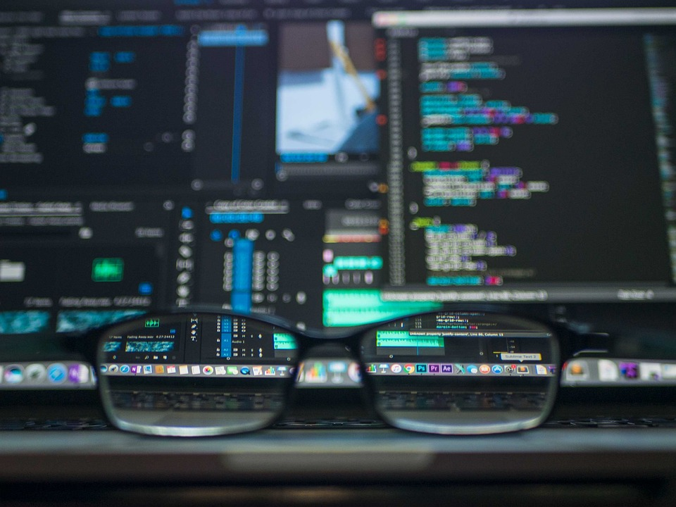 A pair of glasses kept in front of a computer with data