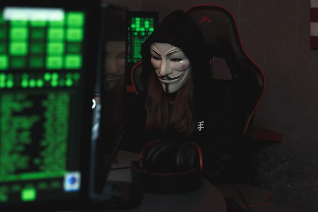 A man with a mask cyberstalking on the internet