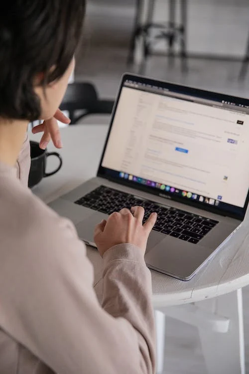 A girl using a laptop to browse a website