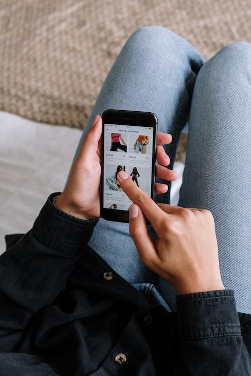 A girl doing online shopping on a smartphone using VPN