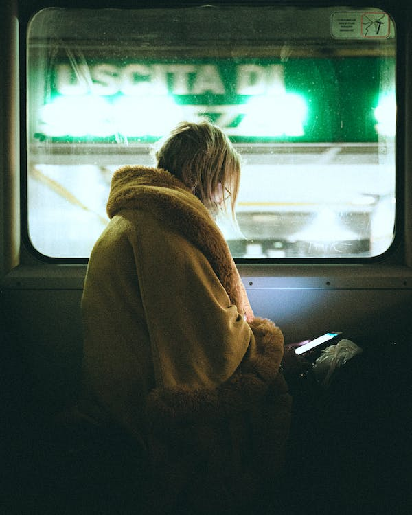 An girl using public WiFi on a train