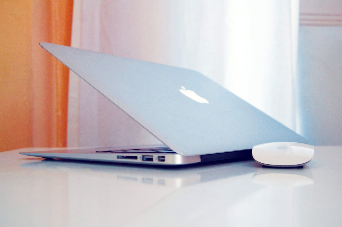 A half-shut Mac laptop