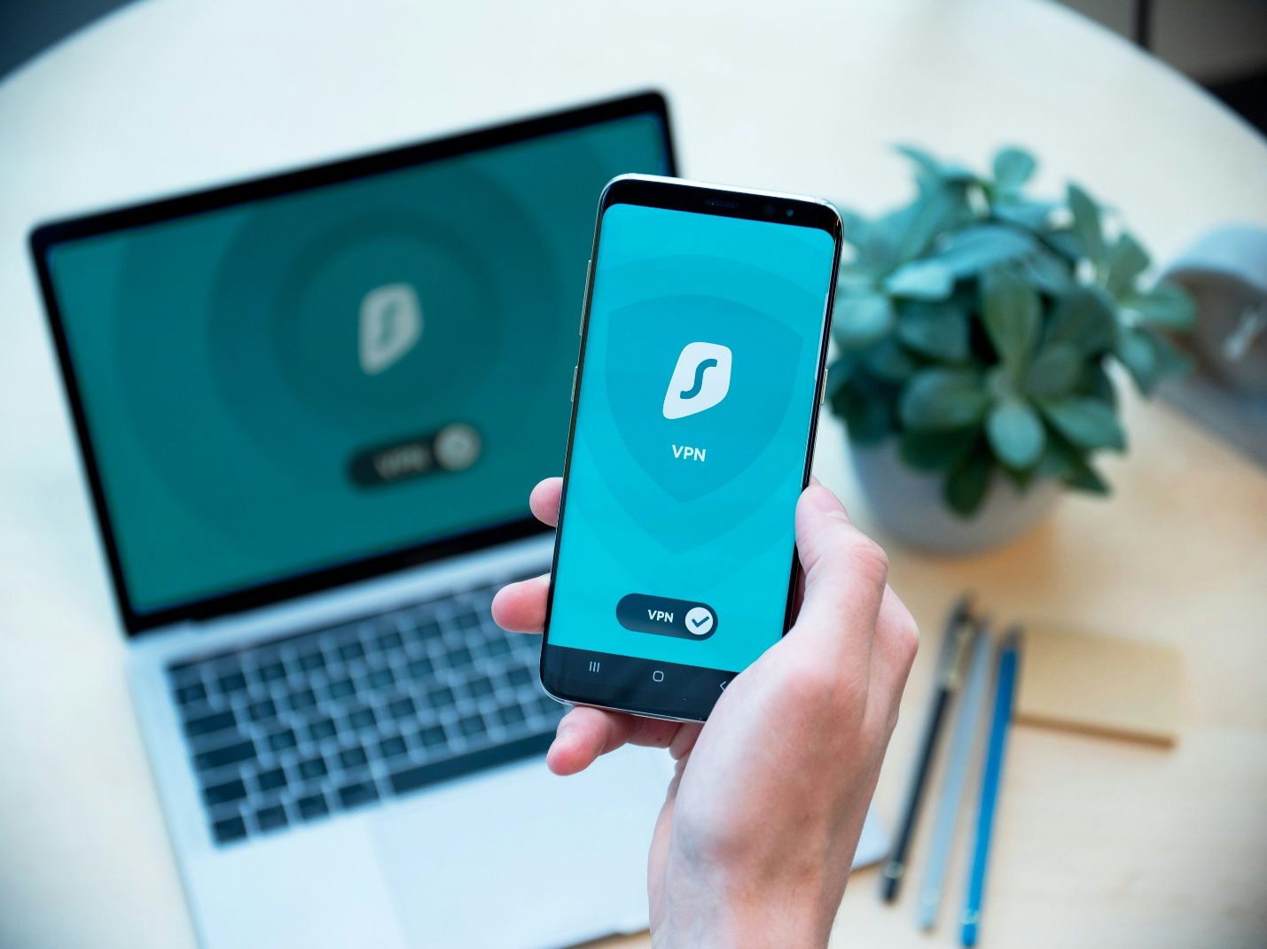 A logo of a VPN on a phone and a laptop