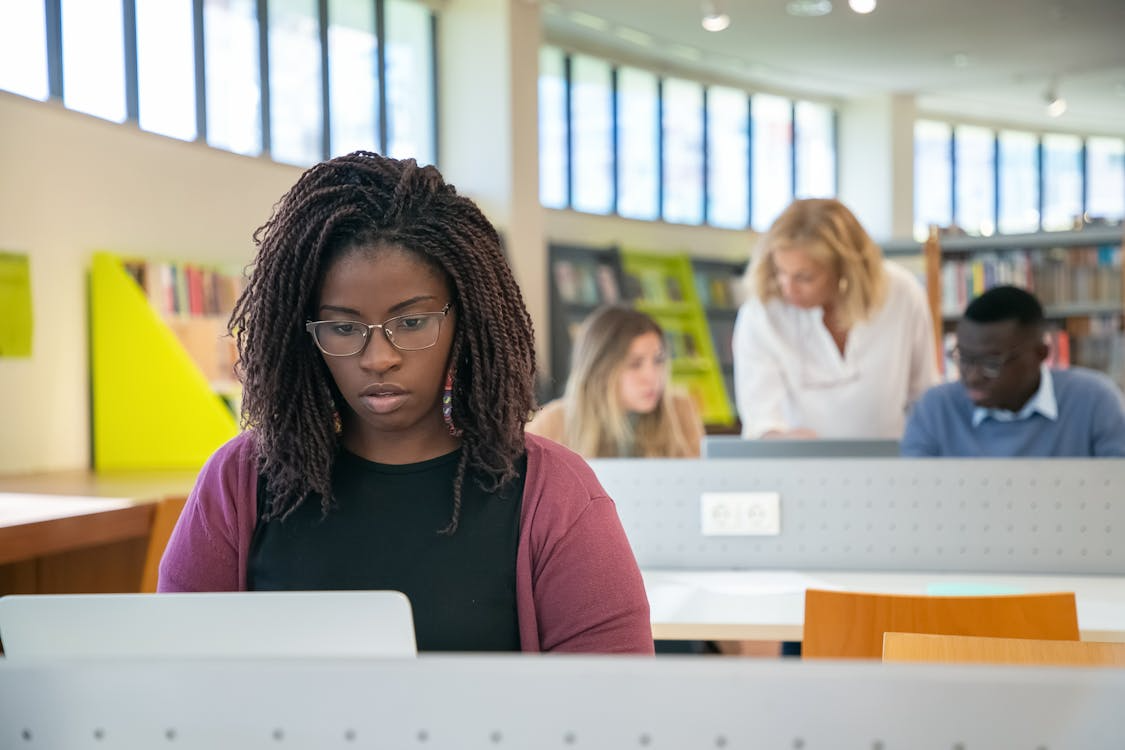 A person using their laptop in the campus library