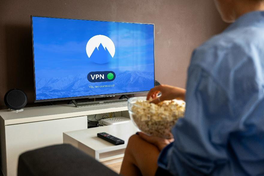 person watching smart TV with VPN connection active on screen