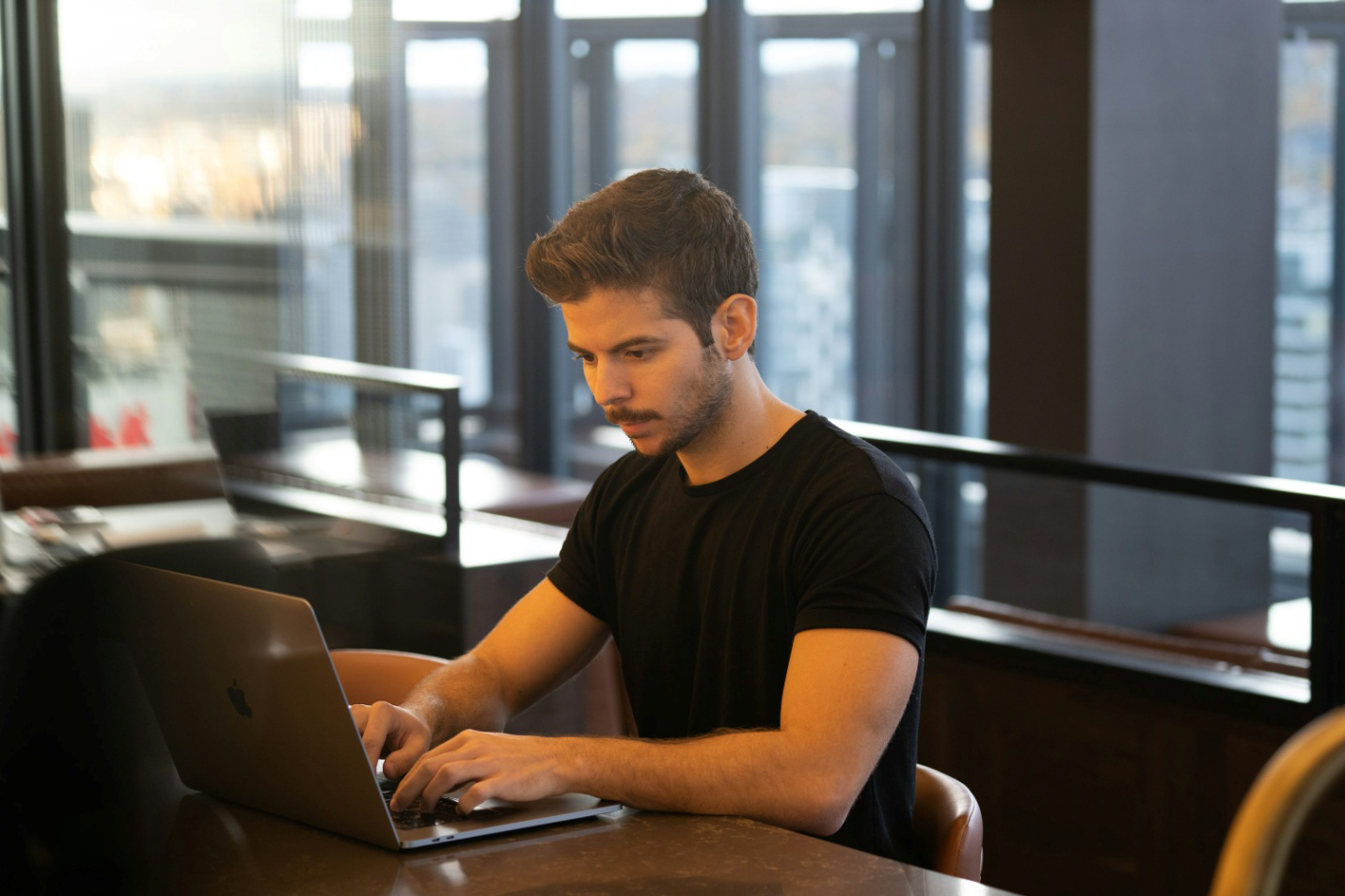 A man typing on a laptop