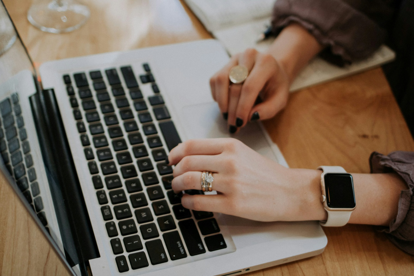 A woman typing on a laptop