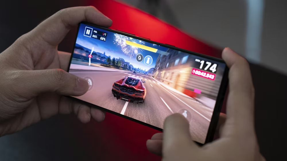 A person playing a video game on their cell phone